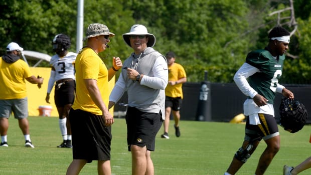 Missouri head football coach Eli Drinkwitz, center, smiles with Ryan Russell, executive director of athletic performance, on the first day of fall practice Monday at the Kadlec Practice Fields. The Tigers are scheduled to open the season Thursday, Sept. 1 against Louisiana Tech